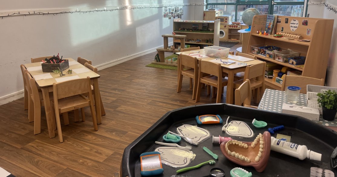 Nursery Room at Busy Bees Norwich Thorpe showing play tables  and tactile wooden toys