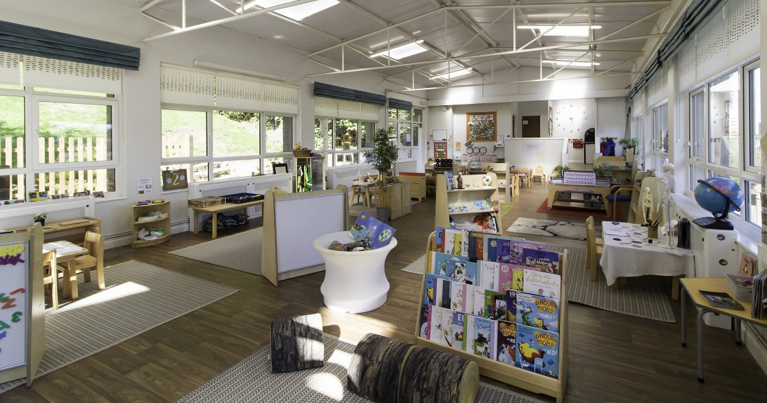 Large Nursery room at Busy Bees Guildford Fitzsimmons showing reading area and a range of other activities for all the children