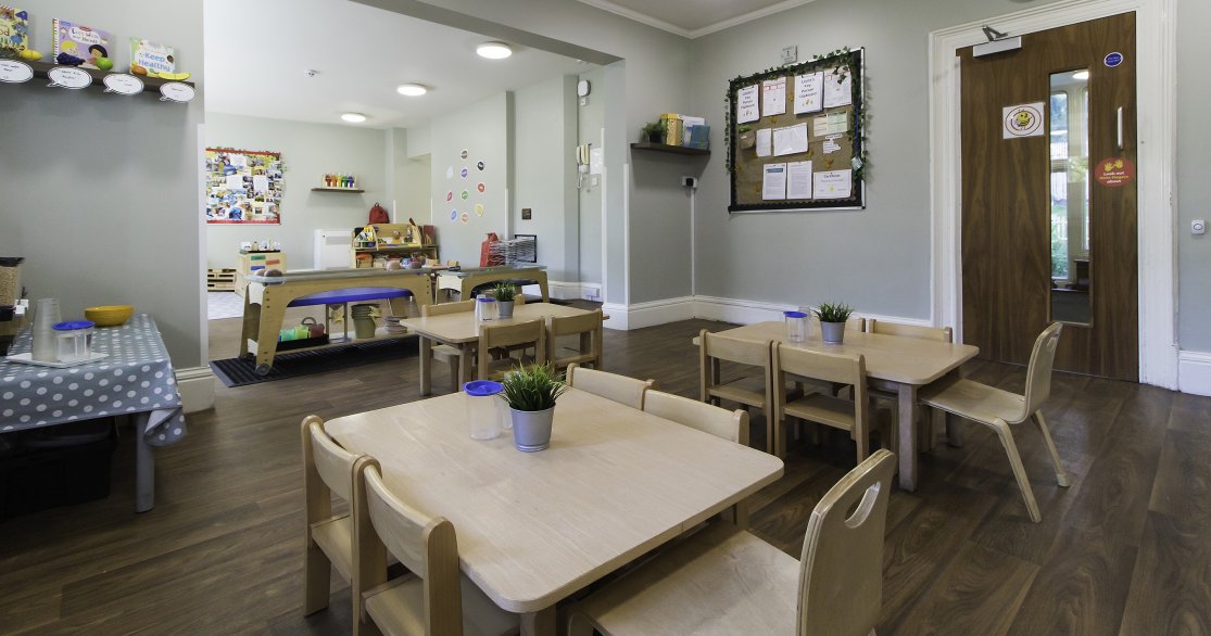 Nursery room at Busy Bees Guildford Fitzsimmons showing dining tables set up for lunch