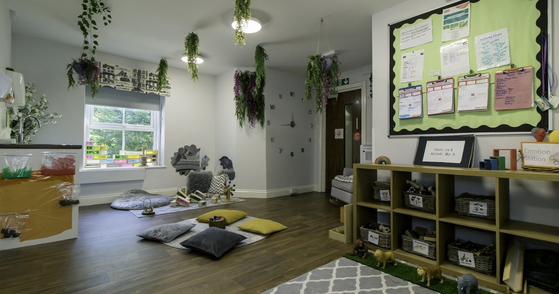 Nursery room at Busy Bees Guildford Fitzsimmons showing cosy area with cushions