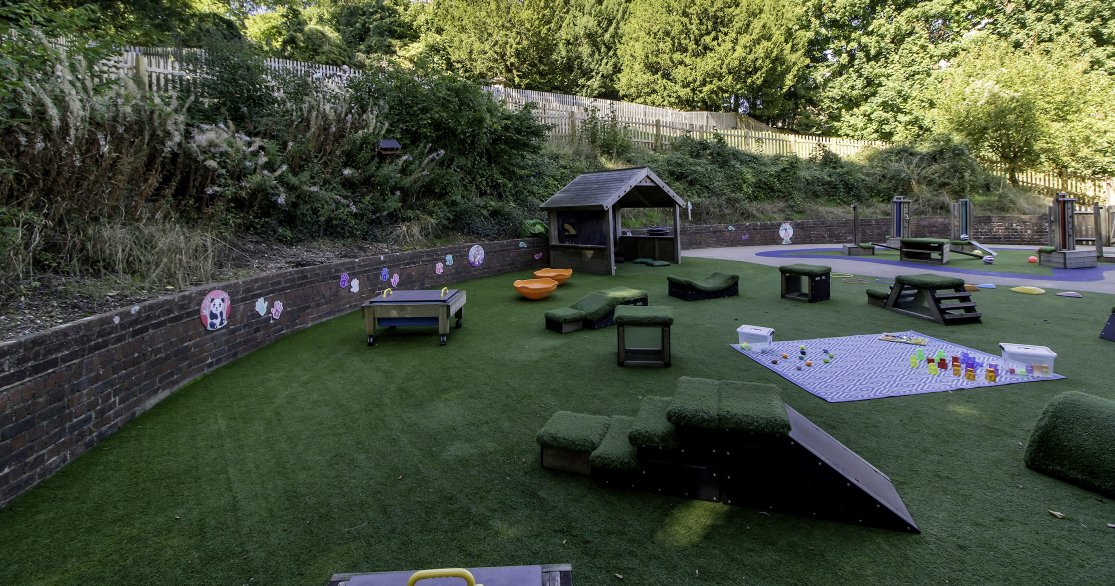 Outdoor Nursery room at Busy Bees Guildford Fitzsimmons showing dining tables set up for luncharea for nursery children at Busy Bees Guildford Fitzsimmons