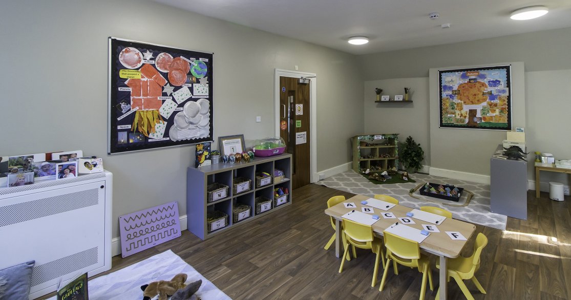 Nursery room at Busy Bees Guildford Fitzsimmons showing tables set up with activities