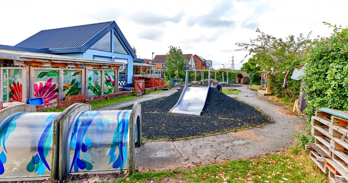 well equipped outdoor space showing slide and crawl tunnels at Newcastle Brunton Kids 1st nursery by Busy Bees